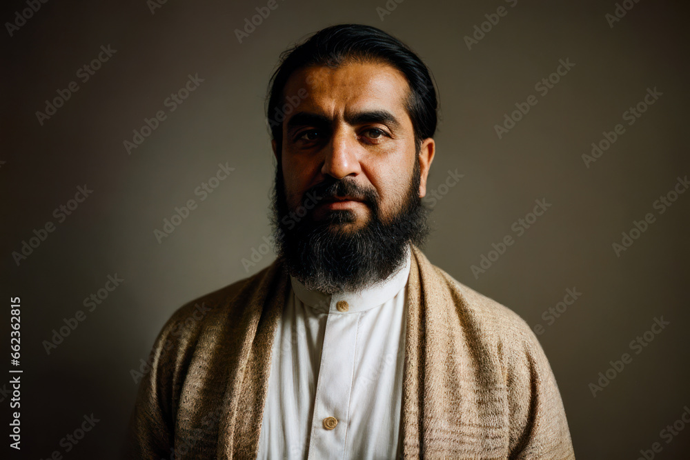 Portrait of the of the old age, bearded Iranian man wearing traditional clothing. Concept of active age Portrait of the of the old age, bearded Iranian man wearing traditional clothing. Concept of active age