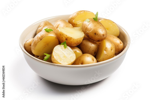 Bowl of boiled new potatoes with peels on white background