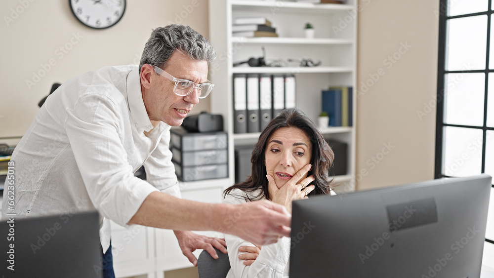 Senior man and woman business worker and boss arguing at office Senior man and woman business worker and boss arguing at office