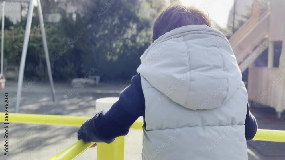 Adorable Boy's Carousel Delight: Sweet Smile Amid Playful Park Adventure