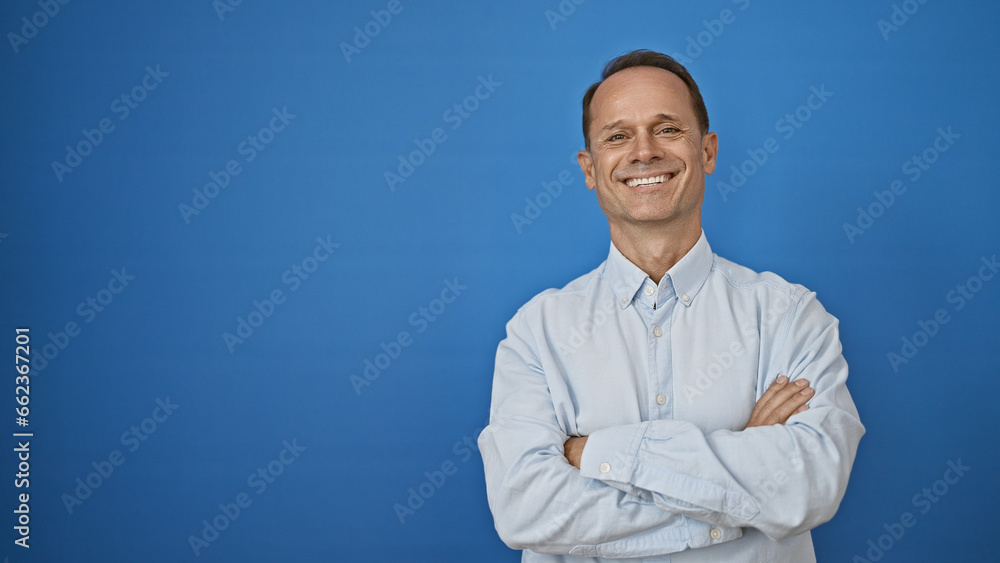 Confident smiling middle age man standing casual, arms crossed with joy, isolated on a white background, radiating happiness, mature and fashionable Confident smiling middle age man standing casual, arms crossed with joy, isolated on a white background, radiating happiness, mature and fashionable