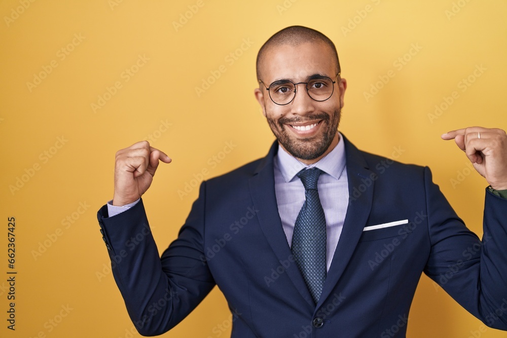 Hispanic man with beard wearing suit and tie looking confident with smile on face, pointing oneself with fingers proud and happy. Hispanic man with beard wearing suit and tie looking confident with smile on face, pointing oneself with fingers proud and happy.