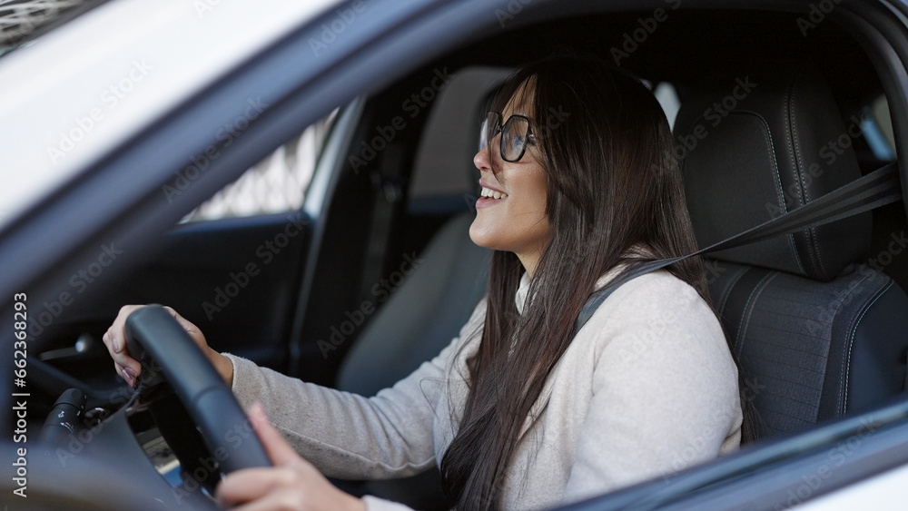 Young beautiful hispanic woman smiling confident driving car at street Young beautiful hispanic woman smiling confident driving car at street
