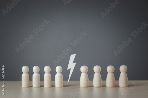 The wooden figure that is split in two on a gray background is like a man on one side and a woman on the other. Concept of equality gender diversity inequality. wooden puppet, wooden doll.