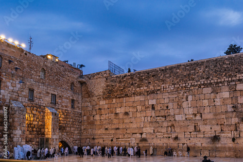 Worshipers praying at the Western or Wailing Wall of Ancient Temple in the early morning