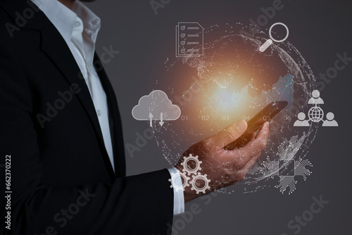 Businessman using smart mobile phone to connect to various networks, global internet connection technology business and digital marketing, finance and banking, digital linkage technology, big data.