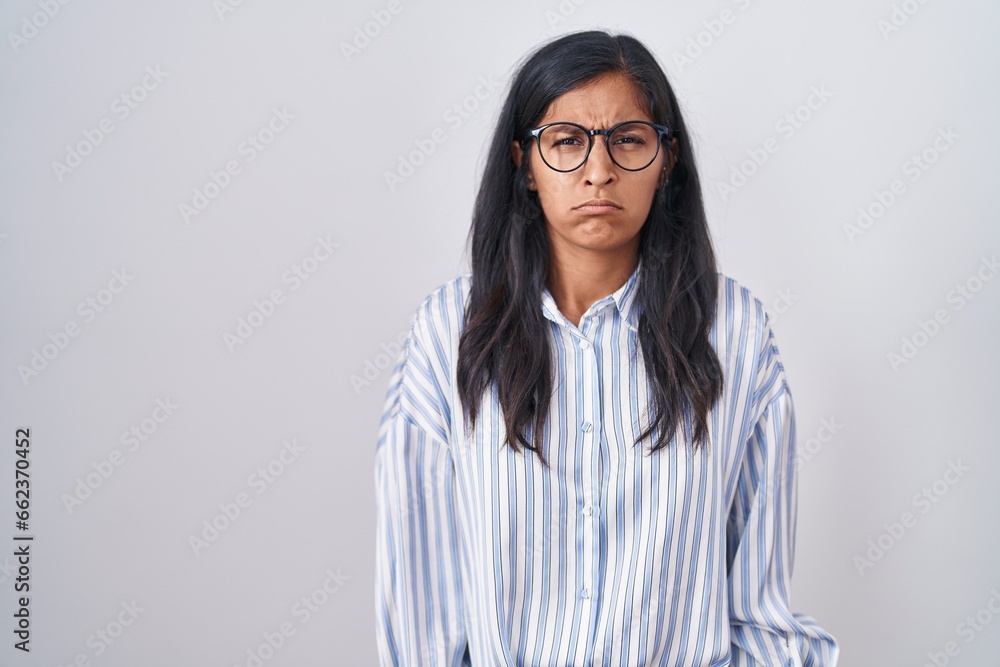 Young hispanic woman wearing glasses skeptic and nervous, frowning upset because of problem. negative person. Young hispanic woman wearing glasses skeptic and nervous, frowning upset because of problem. negative person.