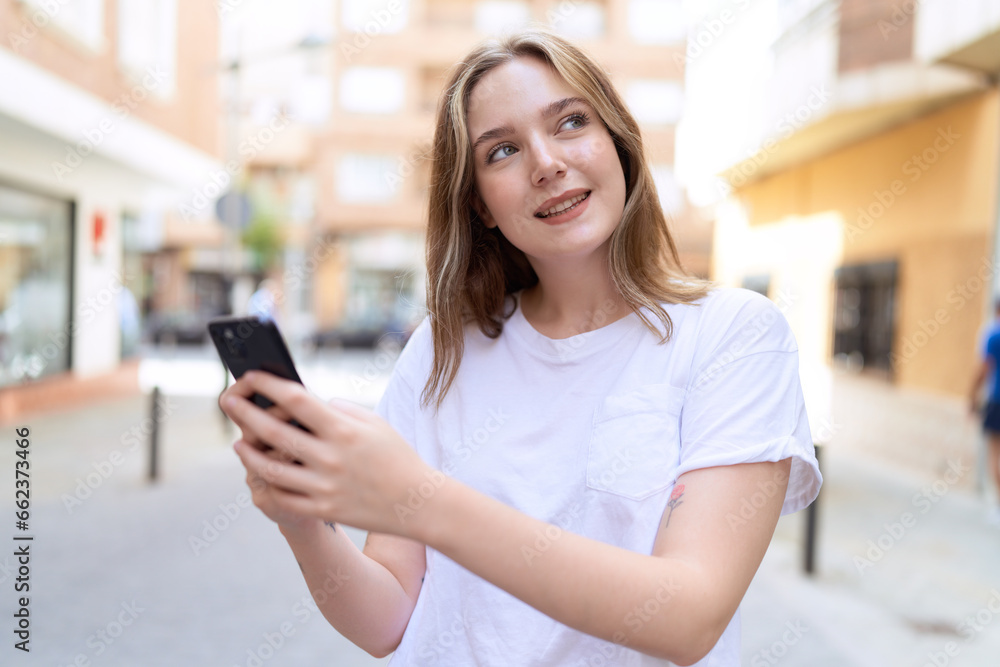 Young caucasian woman smiling confident using smartphone at street Young caucasian woman smiling confident using smartphone at street