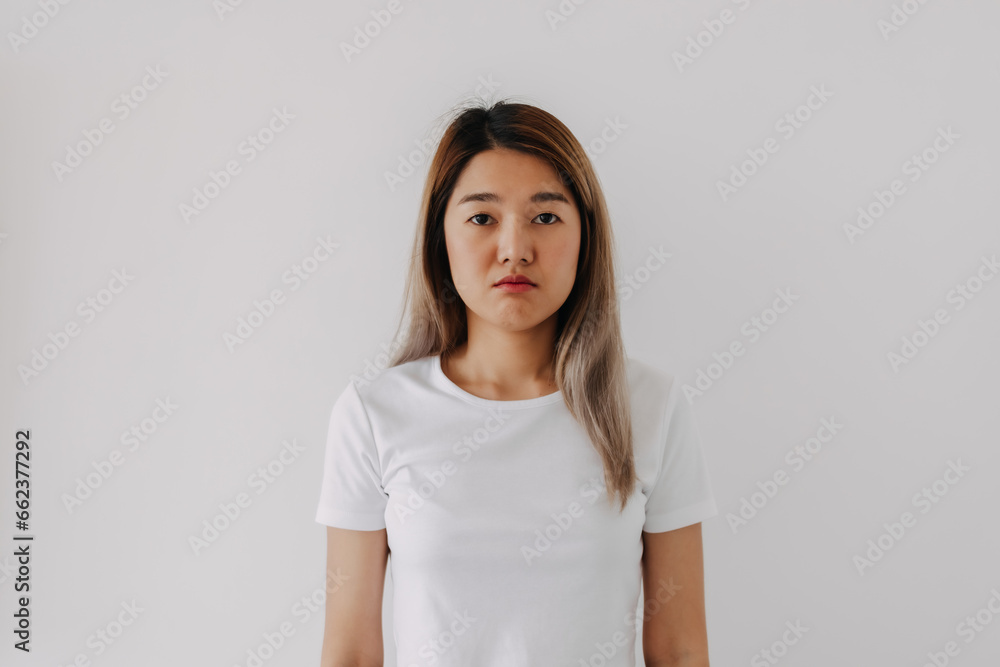 Thai Asian woman serious standing isolated over white background, pout sad face, unhappy. Thai Asian woman serious standing isolated over white background, pout sad face, unhappy.