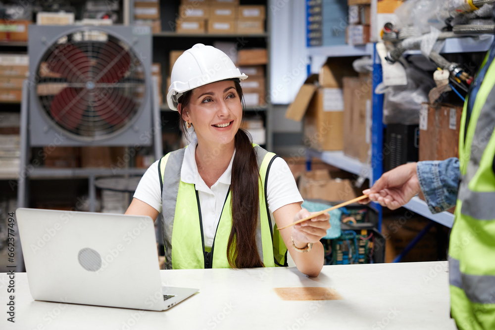 worker giving or taking envelope to coworker in the warehouse storage worker giving or taking envelope to coworker in the warehouse storage