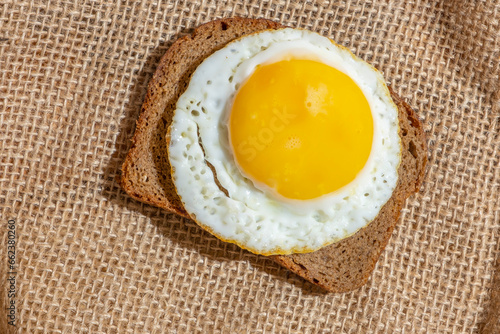 Fotografie Sandwich with sunny side up egg on cotton background.