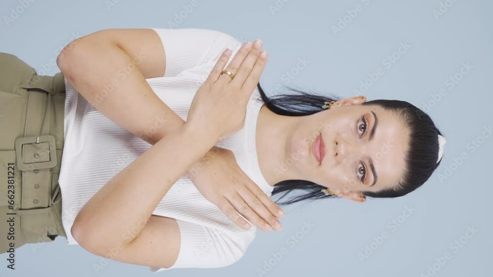 Vertical Video of Woman with negative cross sign looking at camera. Vertical Video of Woman with negative cross sign looking at camera.