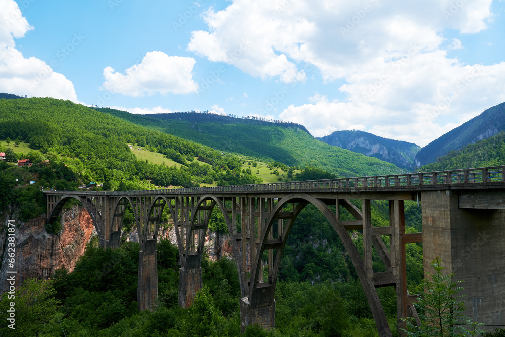 Famous Durdevica bridge in Montenegro. Long bridge over the deep canyon. Beauty mountains nature Famous Durdevica bridge in Montenegro. Long bridge over the deep canyon. Beauty mountains nature