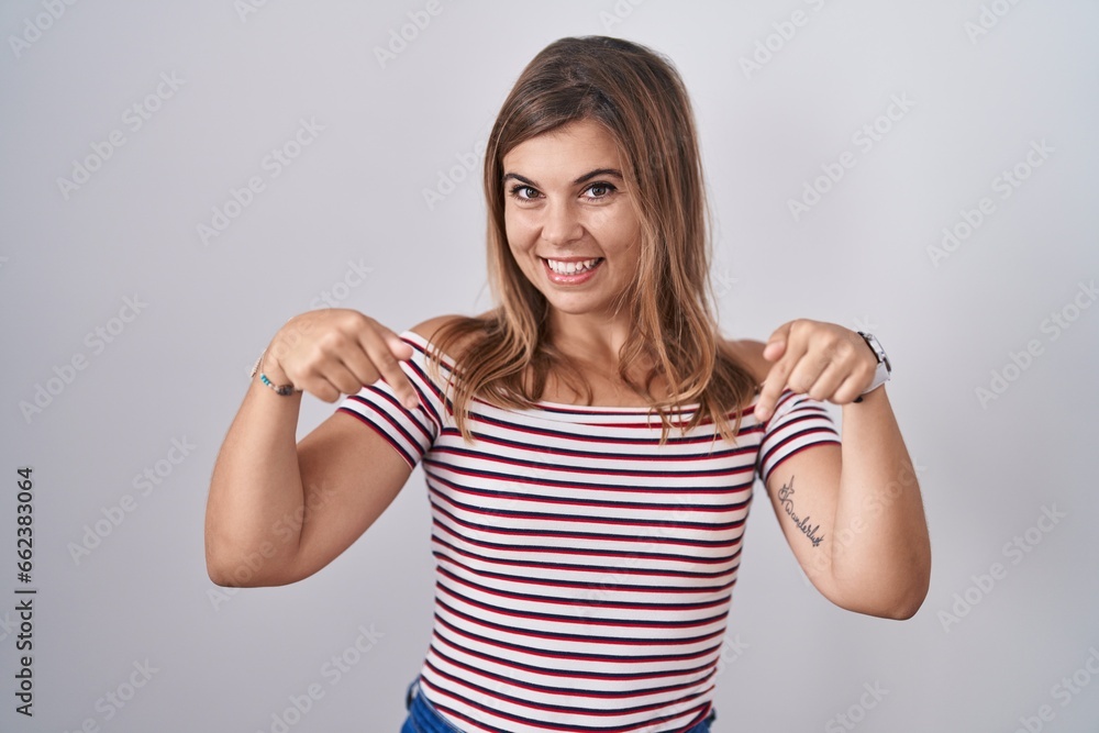 Young hispanic woman standing over isolated background looking confident with smile on face, pointing oneself with fingers proud and happy. Young hispanic woman standing over isolated background looking confident with smile on face, pointing oneself with fingers proud and happy.