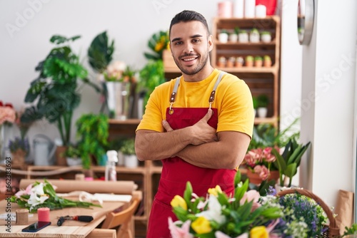 Young hispanic man florist smiling confident standing with arms crossed gesture at florist