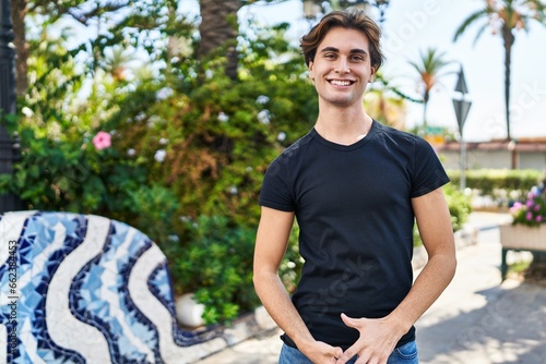 Young caucasian man smiling confident standing at park