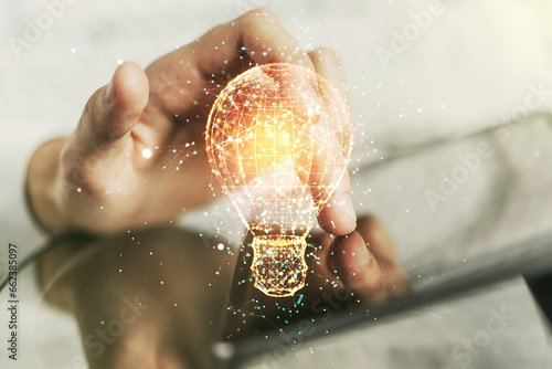 Creative light bulb illustration with finger presses on a digital tablet on background, future technology concept. Multiexposure