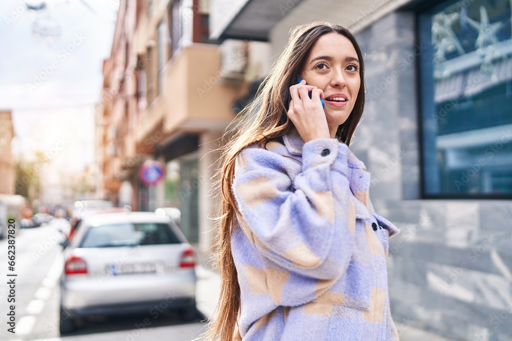 Young beautiful hispanic woman smiling confident talking on the smartphone at street Young beautiful hispanic woman smiling confident talking on the smartphone at street