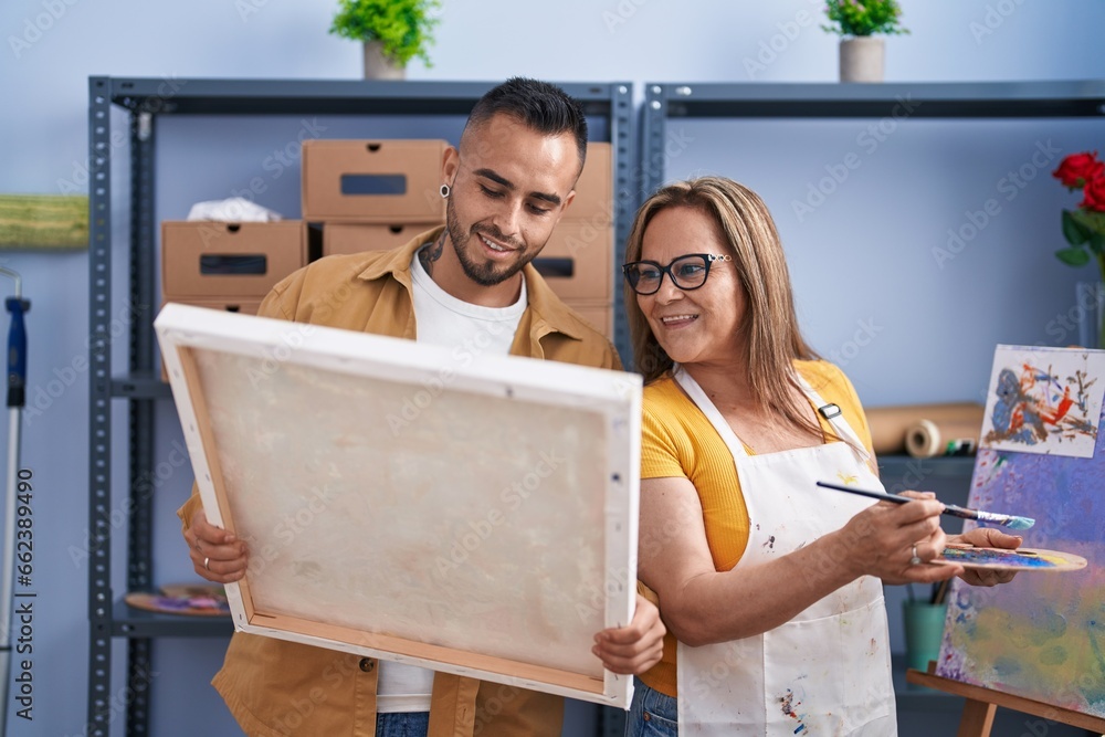 Man and woman artists looking draw standing at art studio Stock Photo ...