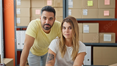 Man and woman ecommerce business workers working together at office