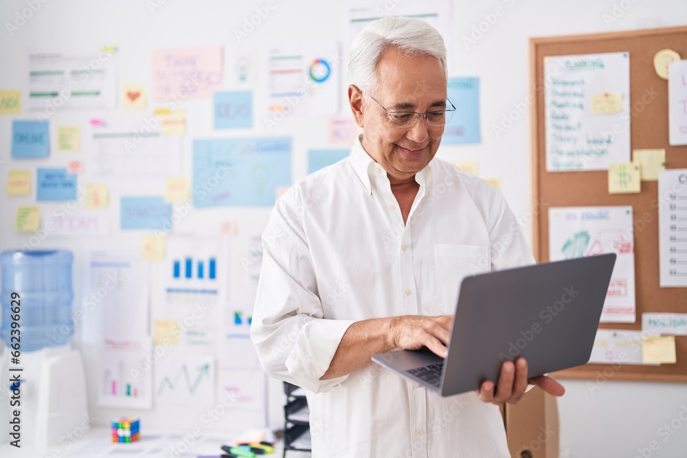 Middle age grey-haired man business worker using laptop working at office Middle age grey-haired man business worker using laptop working at office