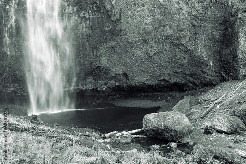 Plunge pool closeup created at the bottom of the lower falls at Multnomah Falls a waterfall located on Multnomah Creek in the Columbia River Gorge at Troutdale, Oregon in black and white photo