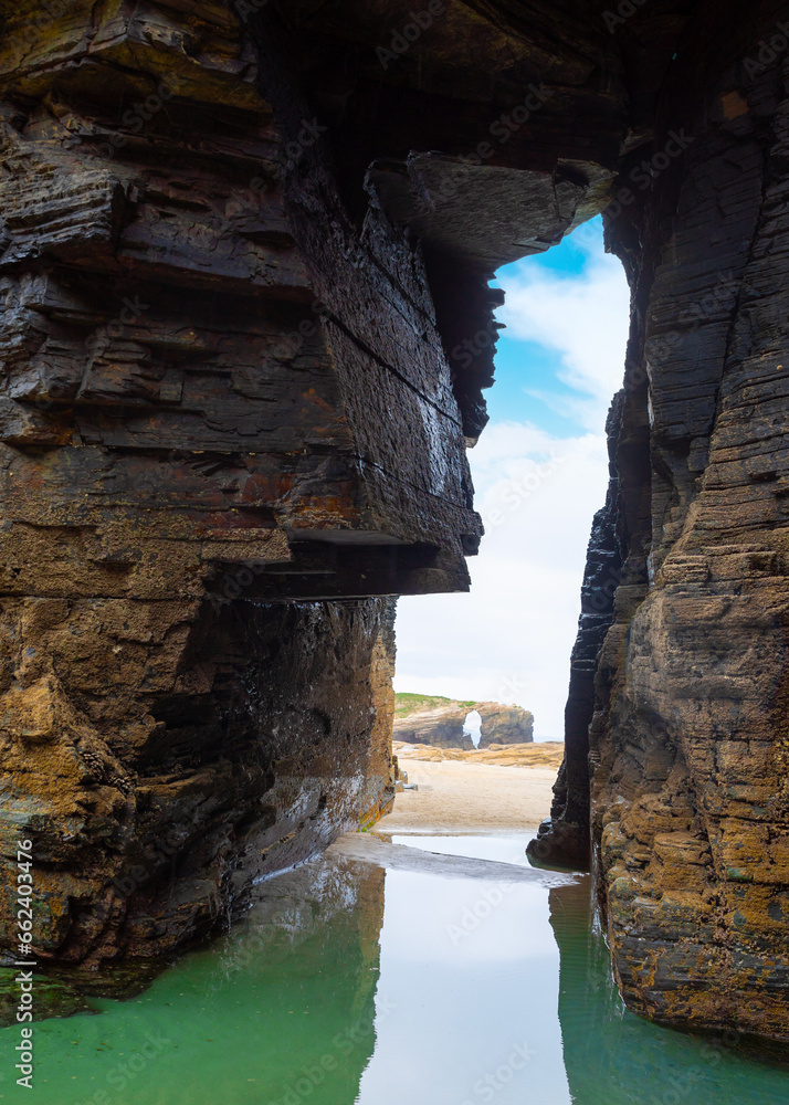 Natural rock arches Cathedrals beach, Playa de las Catedrales at Ribadeo, Galicia, Spain. Famous beach in Northern Spain Atlantic. Natural rock arch on Cathedrals beach in low tide