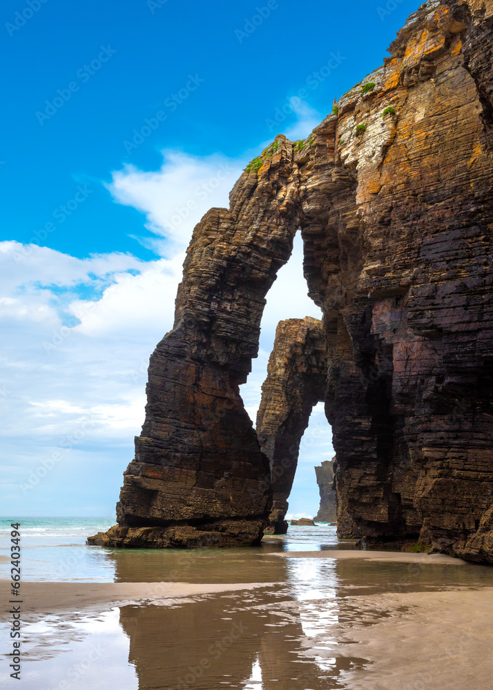 Natural rock arches Cathedrals beach, Playa de las Catedrales at Ribadeo, Galicia, Spain. Famous beach in Northern Spain Atlantic. Natural rock arch on Cathedrals beach in low tide