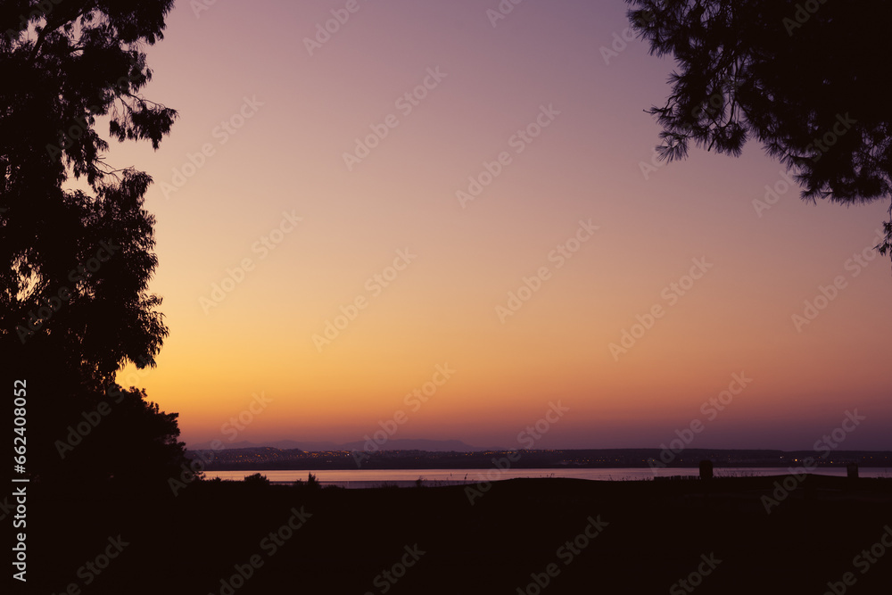 Beautiful photo of nature at sunset. beautiful sunset against the backdrop of trees and a lake. 