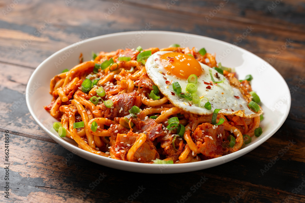 Kimchi Fried Udon Noodle with Fried Egg and bacon. Korean food. Kimchi Fried Udon Noodle with Fried Egg and bacon. Korean food.
