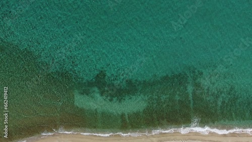 Sea waves on a beach top donw view. Aerial drone video. photo