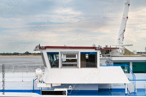 the wheelhouse of a large river ship standing on the roadstead in the port