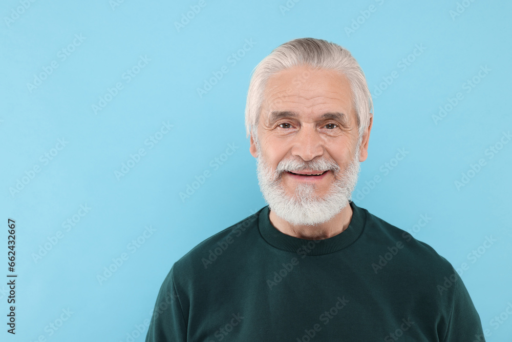 Portrait of handsome senior man on light blue background. Space for text Portrait of handsome senior man on light blue background. Space for text