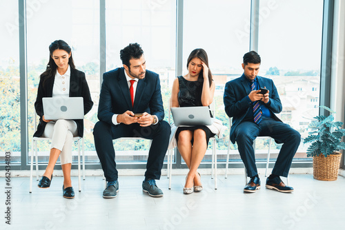 Job seekers and applicants waiting for interview on chairs in office. Job application and recruitment interview qualification concept. Jivy