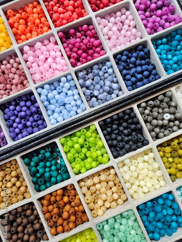 The box is brimming with an array of vibrant beads in various colors