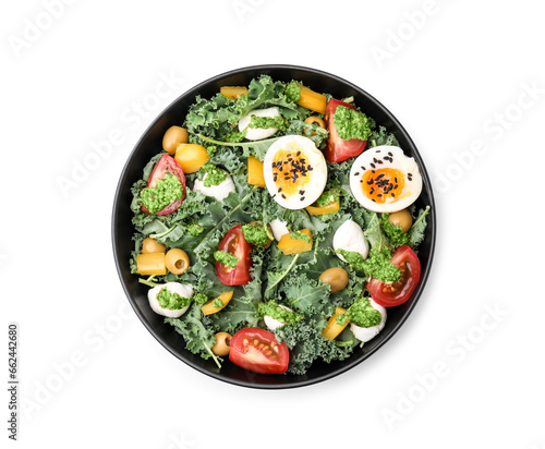 Delicious salad with pesto sauce in bowl isolated on white, top view