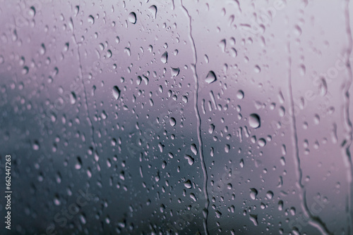 Drops of water on glass on a cold background, rainy weather high humidity, worsening weather forecast selective focus