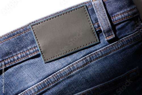 Blank black leather label sewed on a blue denim jeans. Denim jeans with blank label mock up