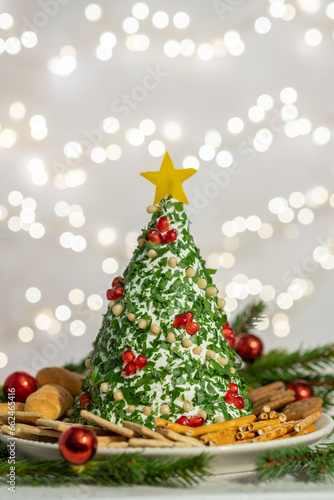 appetizer of Christmas tree made of cheese and decorated with herbs
