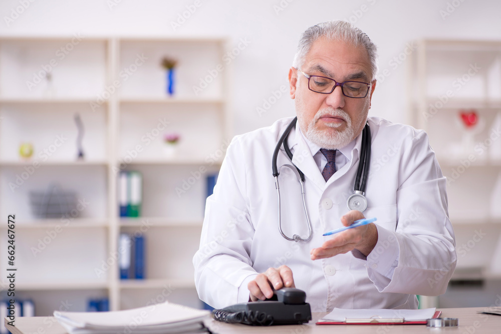 Old male doctor in telemedicine concept Old male doctor in telemedicine concept