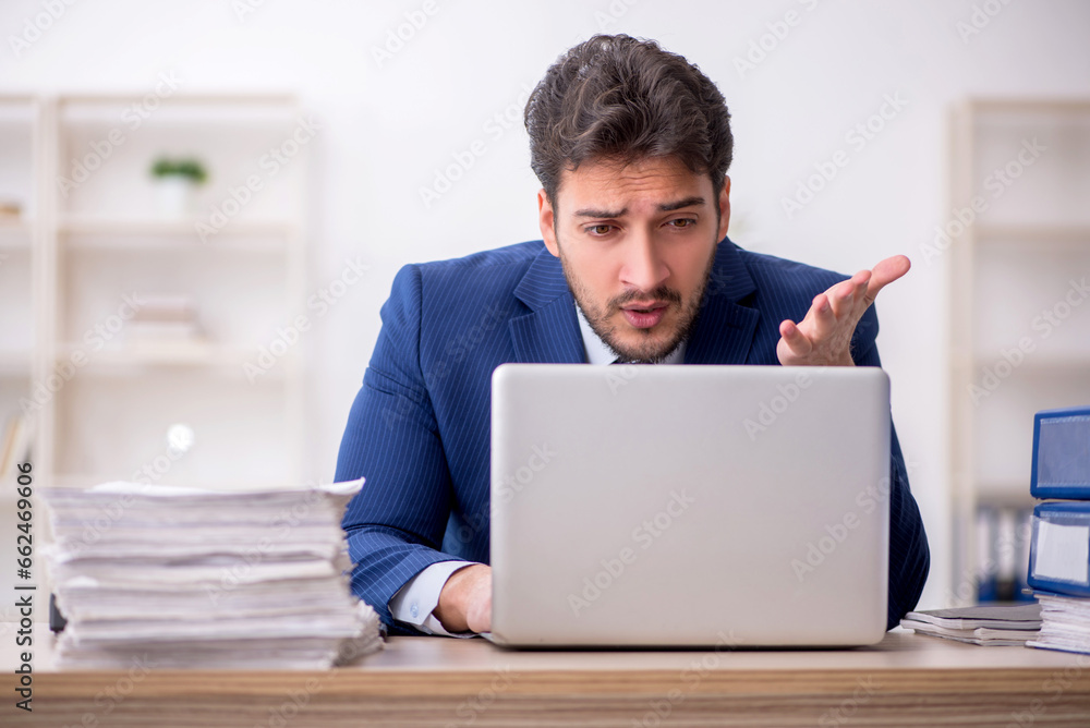 Young male employee working in the office Young male employee working in the office