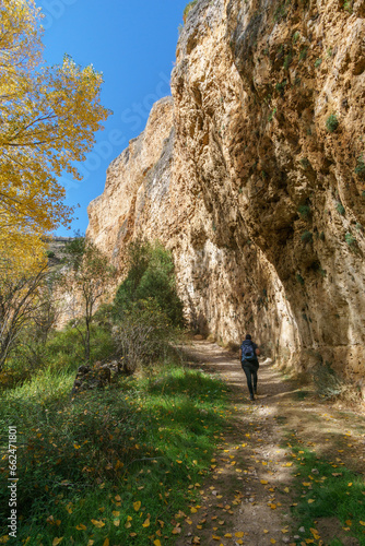 The beautiful path with hiker besides rock formation of the Hoces del Duraton natural park near Sepulveda, Segovia, Spain
