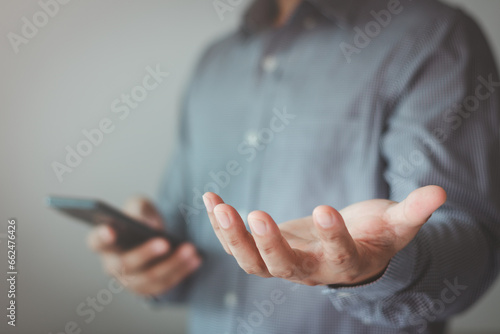 Open hand concept. Young man outstretched in gesture of help empty hand. for give, offer, hold, receive, showing, present, display, or product on a person's palm on a white background. Business theme. photo