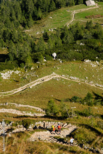 Blick ins Tal an steiler Hangkante mit Wanderern auf Wanderweg photo