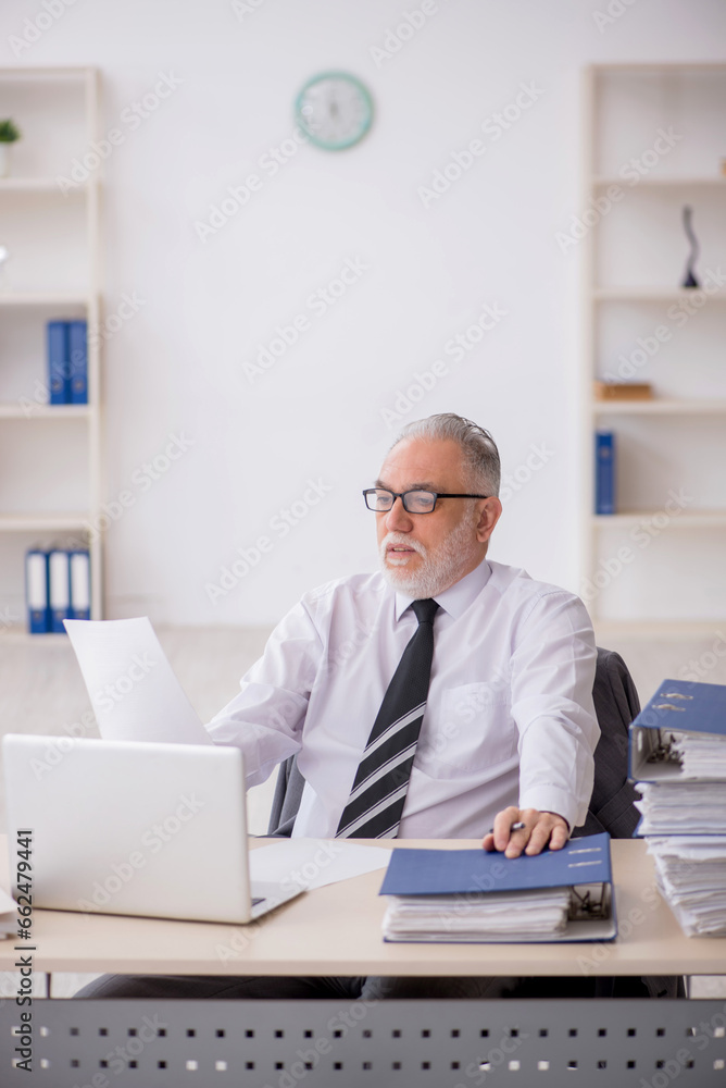 Old male employee and too much work in the office Old male employee and too much work in the office