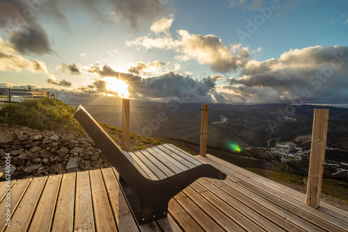 Empty garden bench during sunset, at the Cabeço da Urra viewpoint in the town of Pampilhosa da Serra, district of Coimbra, Portugal photo
