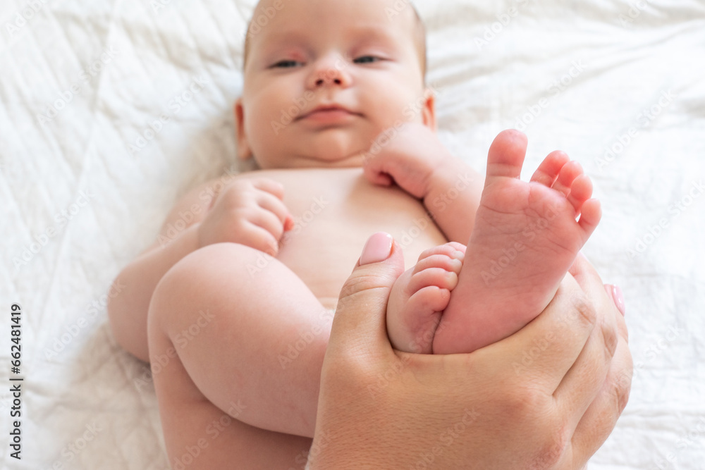 Mother's playtime with baby's tiny feet. Concept of cherished maternal moments Mother's playtime with baby's tiny feet. Concept of cherished maternal moments