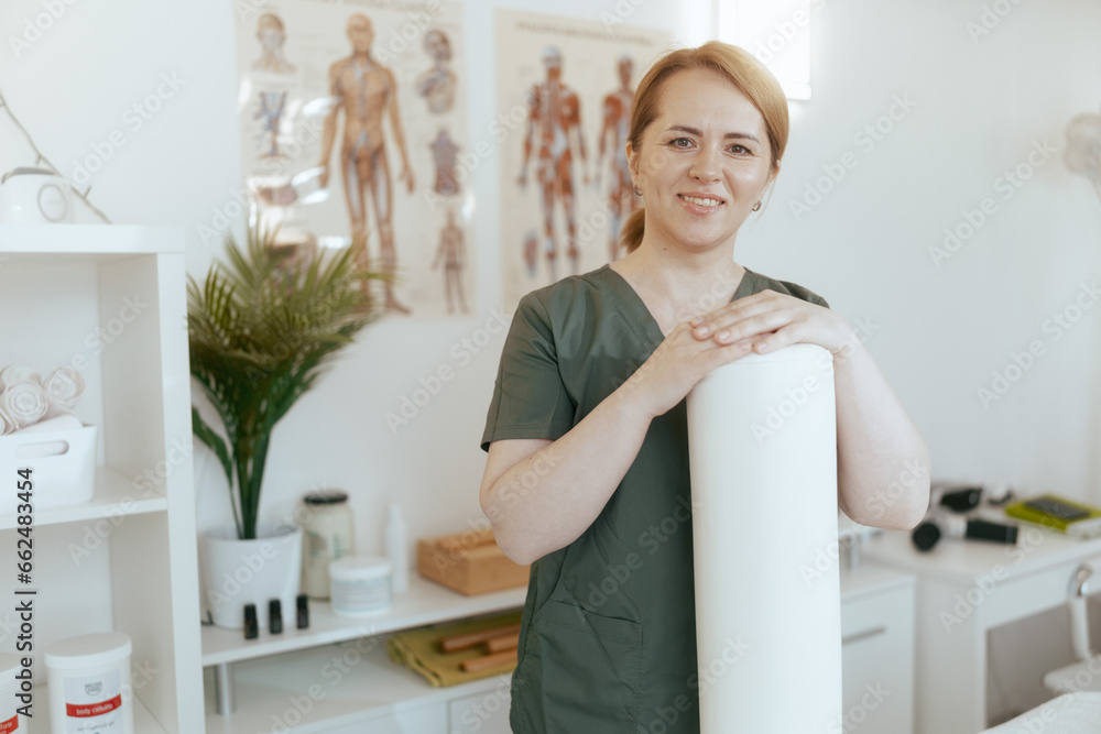 happy massage therapist woman in massage cabinet happy massage therapist woman in massage cabinet