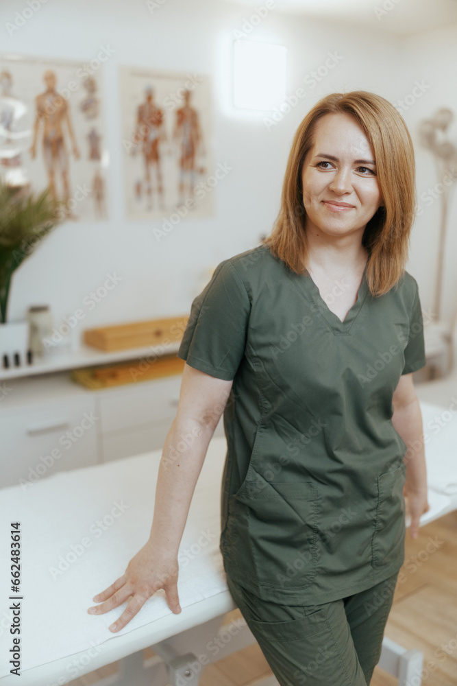 happy female medical massage therapist looking at camera happy female medical massage therapist looking at camera