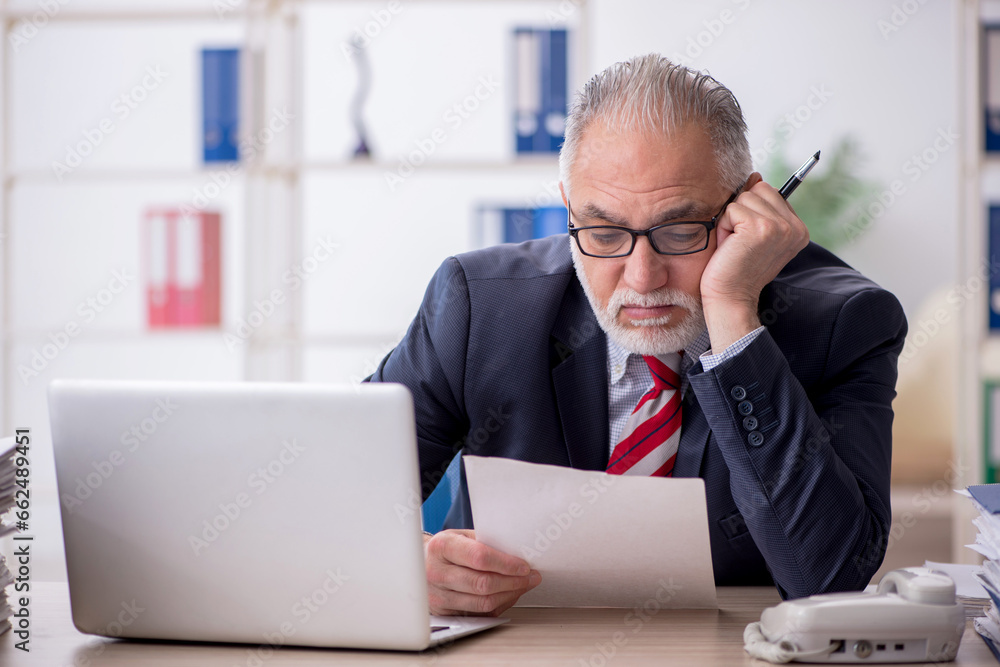Old male employee and too much work in the office Old male employee and too much work in the office